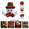 Christmas snowman decoration: white background, red, green and gold striped hat, black eyes, red nose and white arms full image